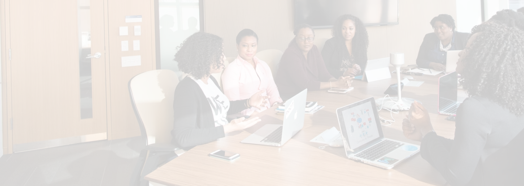 Team members talking in a conference room